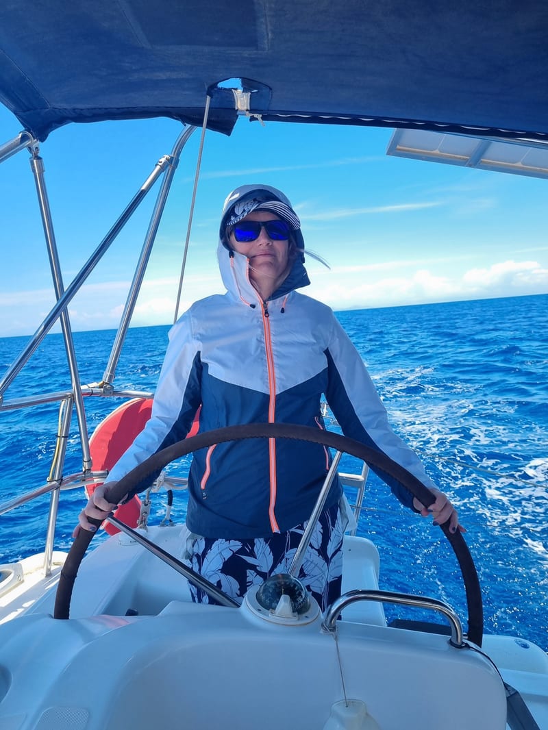 Mila Zaharieva at the helm of a sailing yacht